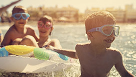 Children playing in the water at the beach.