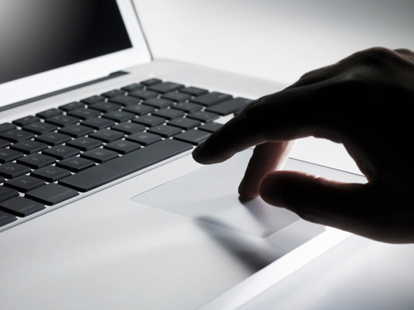 finger on a laptop