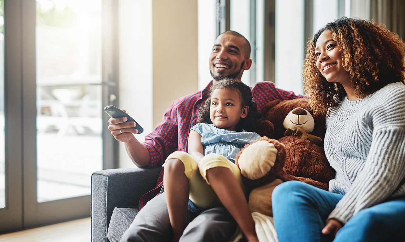 Family smiling on couch