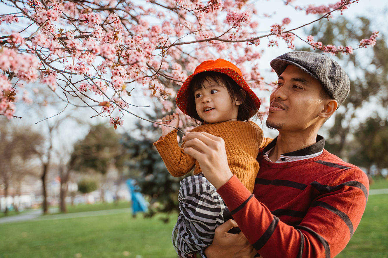 Young family smiling on a commuter train.