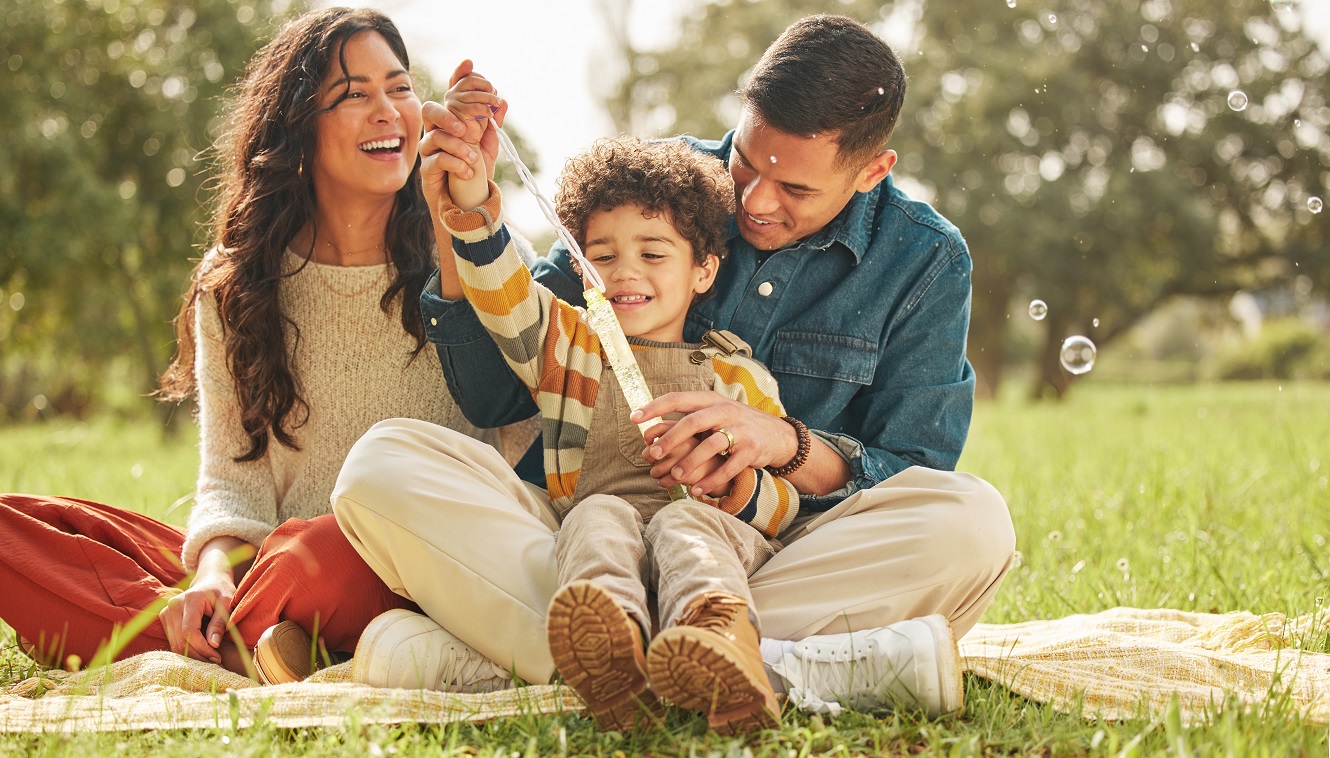 Young family smiling on a commuter train.