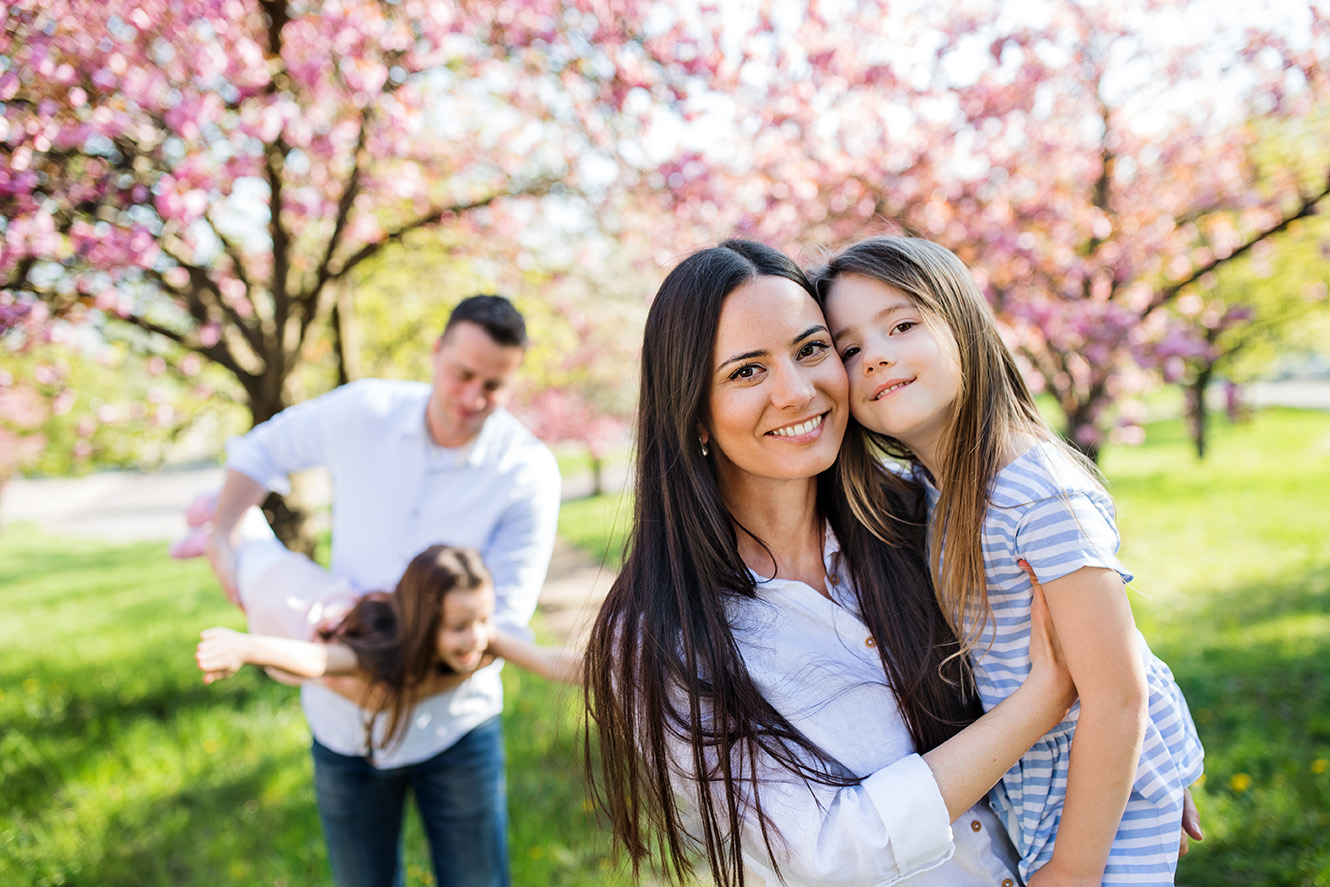 Family outside with cherry blossom tree